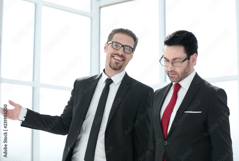 Two employees discuss the results of their work Two employees discuss the results of their work