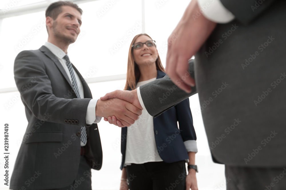 Business shaking hands in the office Business shaking hands in the office
