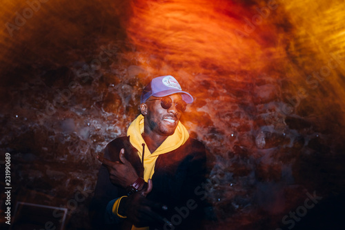 Fényképezés African man rapper among colorful light. Long exposure