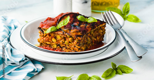 banner of gluten free vegan lasagna. from grilled eggplant, green peas, lentils and vegetables. delicious healthy comfort food for the whole family for the holidays. italian parmigiana