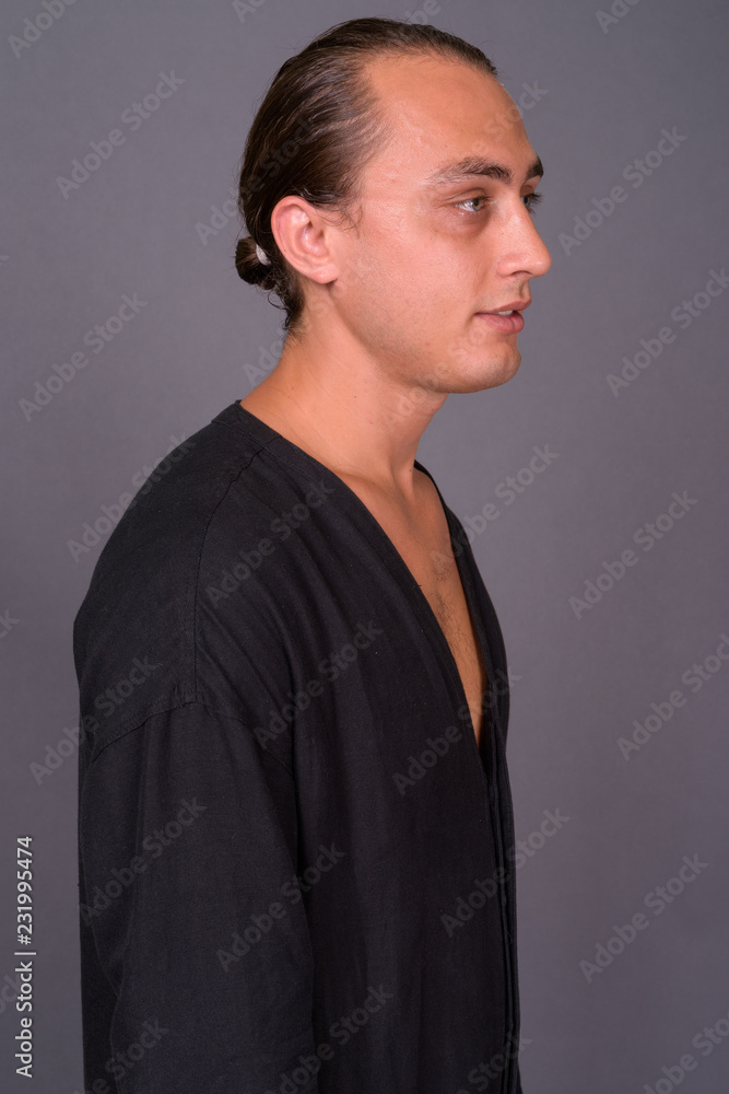Portrait of young handsome man against gray background Portrait of young handsome man against gray background