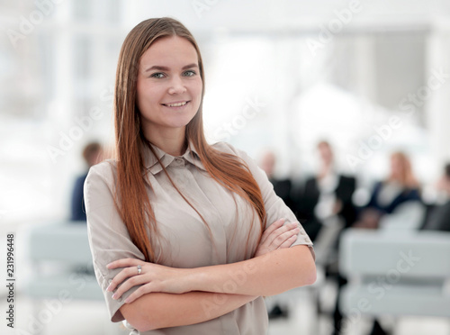 portrait of smiling business woman on the background of the office.