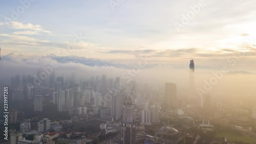 4k hyper lapse dronelapse aerial view of sunrise at Kuala Lumpur city skyline.  Tilt down