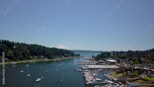 Aerial View of Gig Harbor Washington, Drone is Ascending and Moving Forward, Summer Day Cloudless, Boatig Activities and Small Town Living. Mt. Rainier Over Looking Gig Harbor. photo