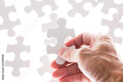 Man hand holding jigsaw puzzle