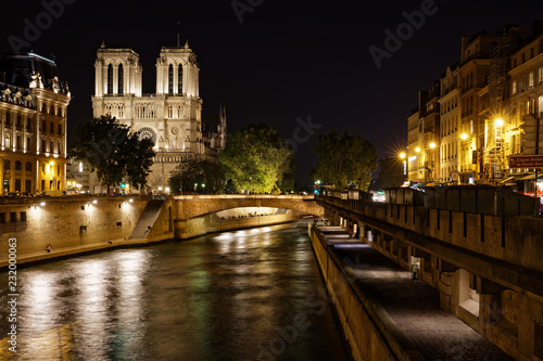 Paris, France - May 20, 2018: View of the night scenery of Cathédrale Notre-Dame de Paris and riverside over Seine river