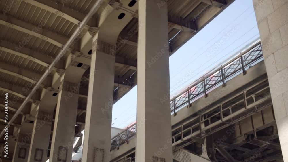Metal pillars of the bridge and train passing in background Metal pillars of the bridge and train passing in background