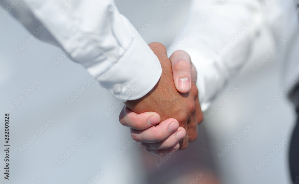 Close-up photo of handshake of two successful businessmen Close-up photo of handshake of two successful businessmen