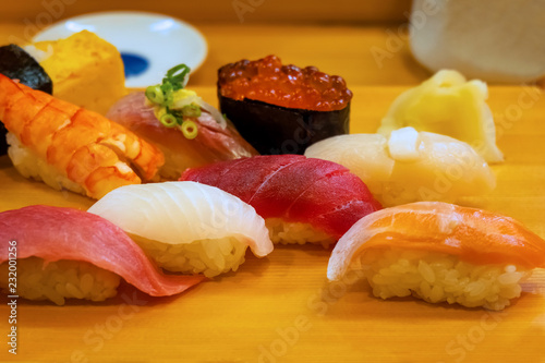 A set of japanese traditional sushi set  beautifully decorated on a wood plate photo