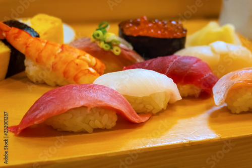 A set of japanese traditional sushi set beautifully decorated on a wood plate