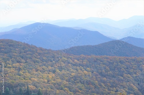 The fantastic view from Brasstown Bald mountain ( the highest mountain in Georgia) colorful in Fall season with white fluffy clouds and blue sky, North Georgia in USA.