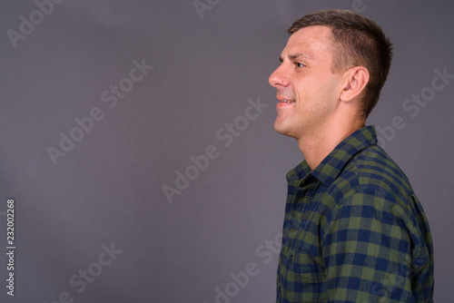 Handsome man with short hair against gray background