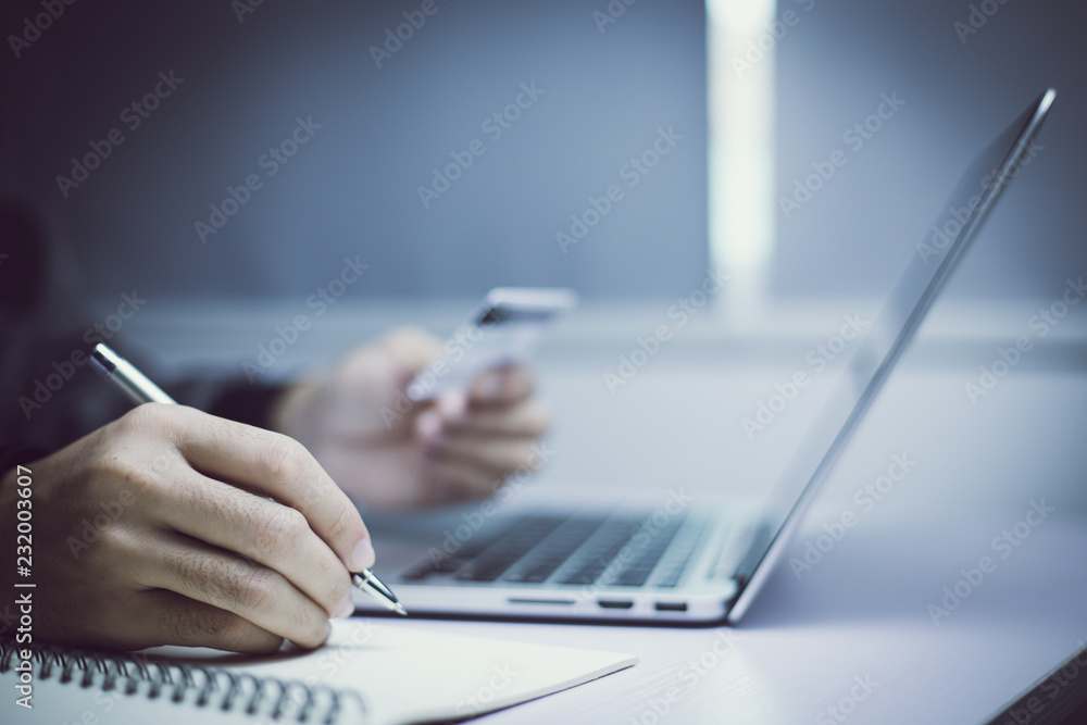 Fototapeta premium Holding Credit Card And Using Laptop