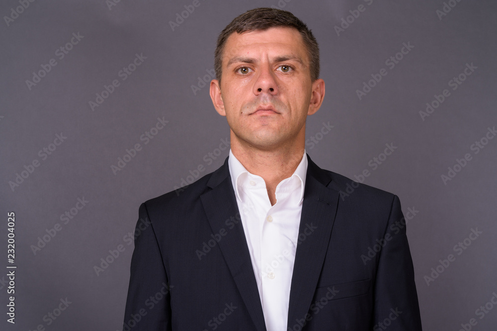 Handsome businessman with short hair against gray background Handsome businessman with short hair against gray background