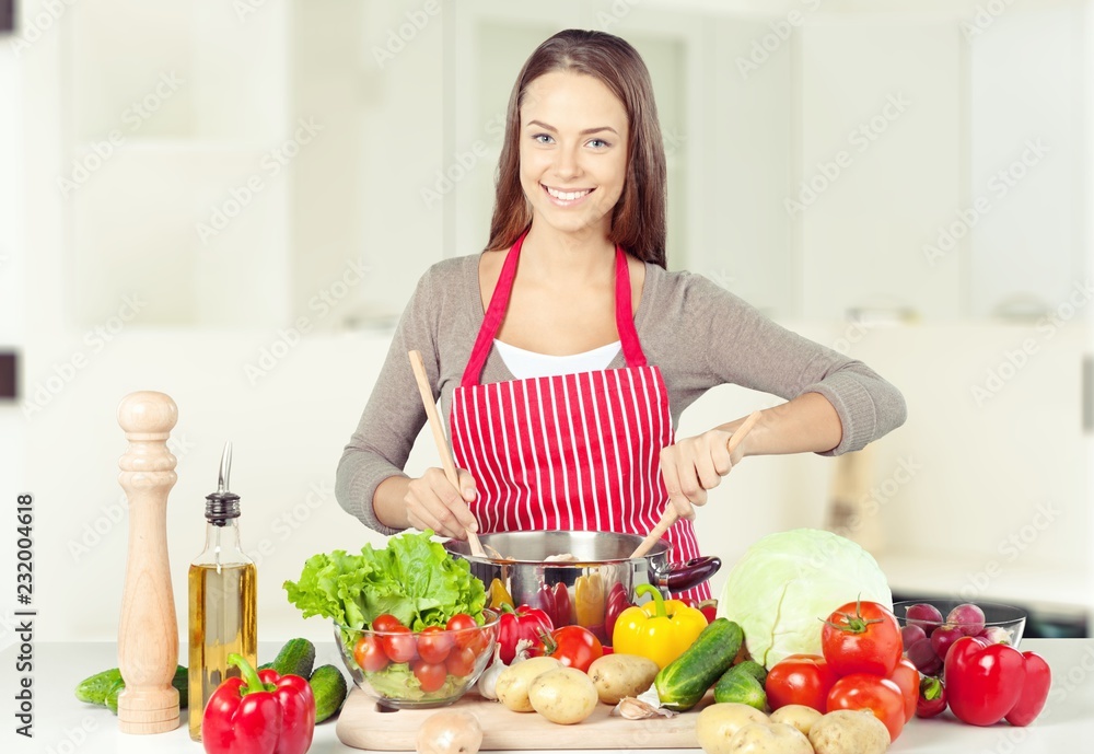 Young beautiful woman Cooking in kitchen Young beautiful woman Cooking in kitchen