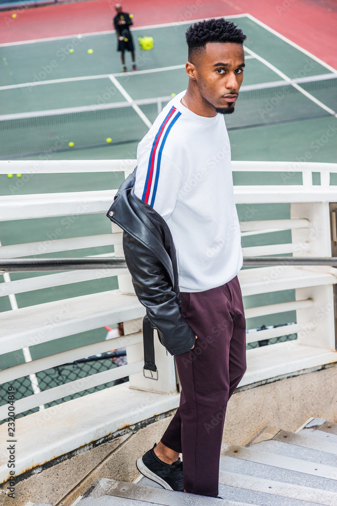 Man Casual Fashion in New York. Young Black Guy with beard, short afro  hair, wearing white