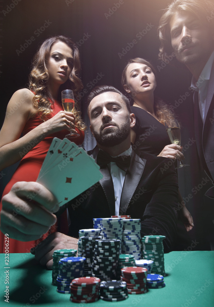concentrated men and women playing poker in casino concentrated men and women playing poker in casino
