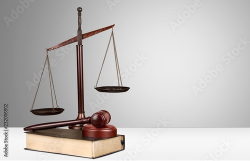 Justice Scales, gavel and books on light