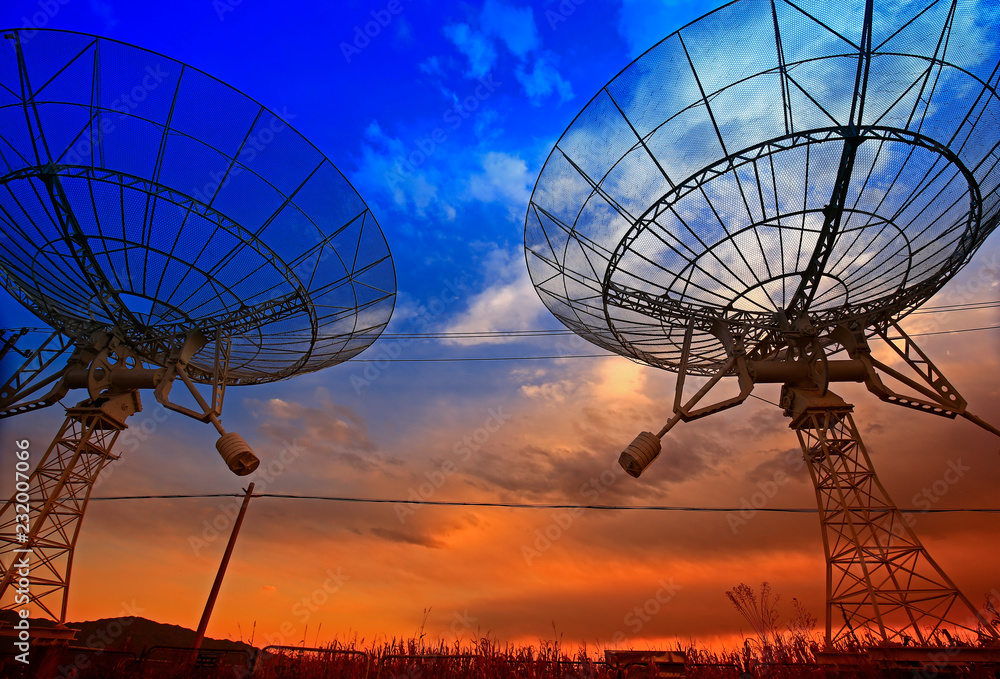 The silhouette of a radio telescope observatory