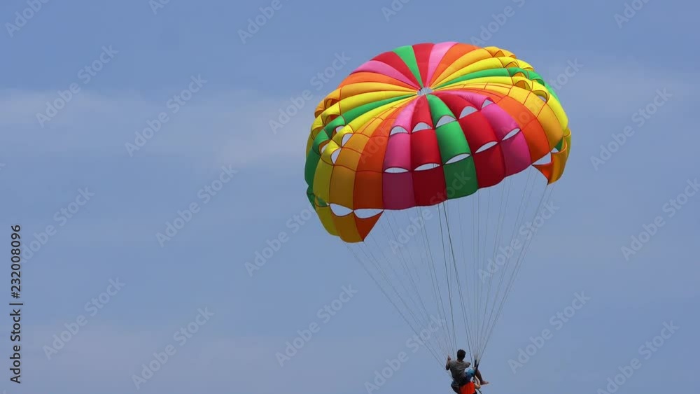The tourist Flying on a parachute at patong beach The tourist Flying on a parachute at patong beach