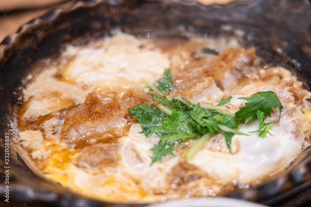 Close up of nabe miso soup with onsen egg and tonkutsu. Close up of nabe miso soup with onsen egg and tonkutsu.