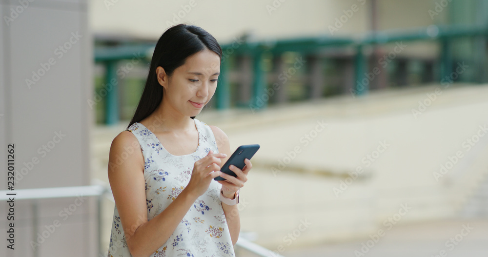 Woman use of mobile phone out of the station Woman use of mobile phone out of the station