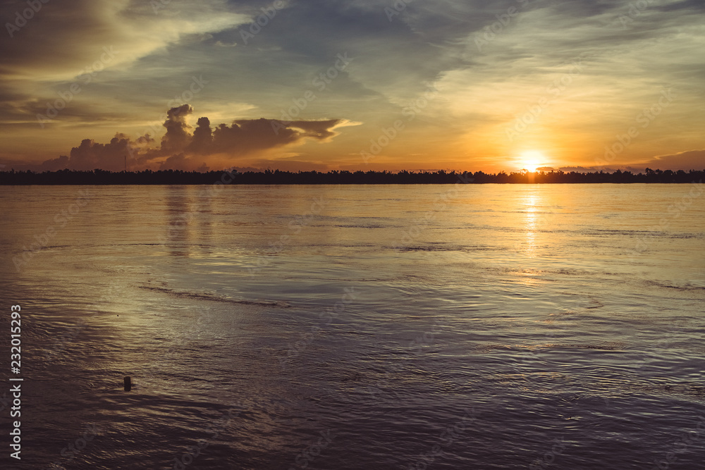 magical sunset with reflections in the mekong river
