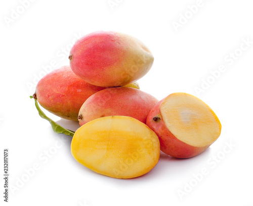 mango with slices and green leaves isolated on white background. healthy food.