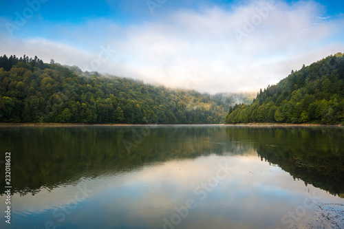 Morning view on foggy Shaori Lake at sunrise Georgia country