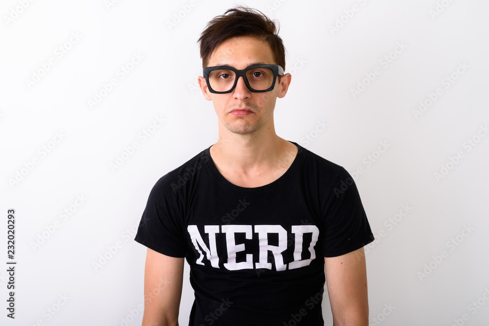 Studio shot of young nerd man wearing eyeglasses against white b Studio shot of young nerd man wearing eyeglasses against white b