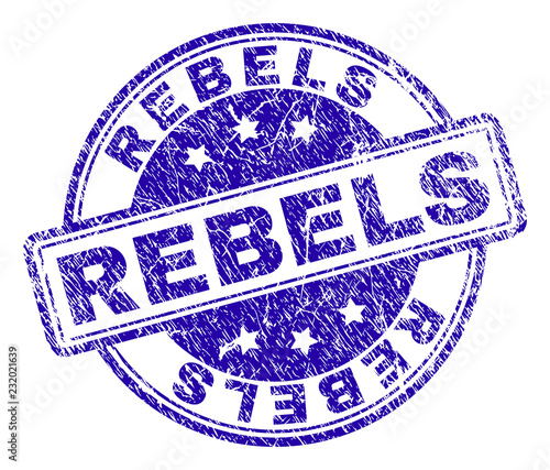 REBELS stamp seal imprint with grunge texture. Designed with rounded rectangles and circles. Blue vector rubber print of REBELS label with grunge texture. photo