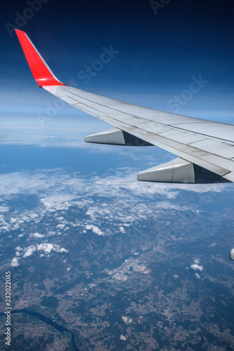 airplane window view - Sky and wing visible