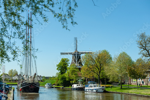 A Classic Dutch Windmill in the city of Dokkum, Friesland, in the Northern parts of the Netherlands, as seen on a bright sunny spring afternoon