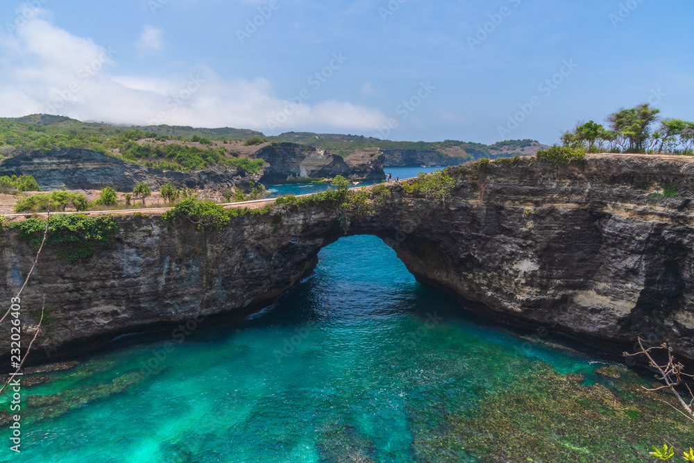 Rock coastline. Stone arch over the sea. Broken beach, Nusa Penida ,Indonesia.
Rock coastline. Stone arch over the sea. Broken beach, Nusa Penida ,Indonesia.