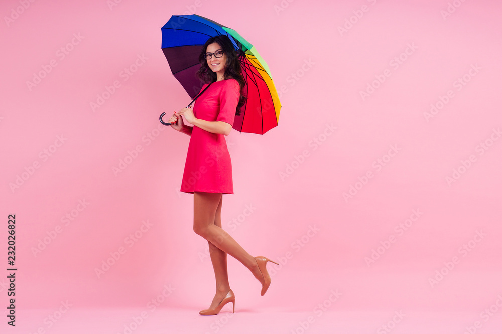 beautiful brunette girl in the studio on a pink background in the style dress with rainbow an umbrella beautiful brunette girl in the studio on a pink background in the style dress with rainbow an umbrella
