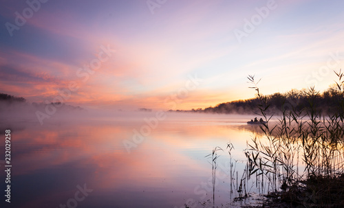 lake at sunrise in pink fog and clouds