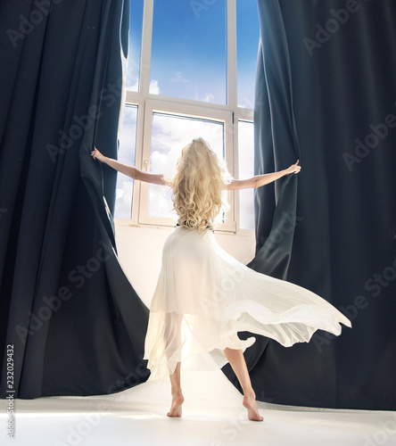 Attractive blonde exposing a huge window photo