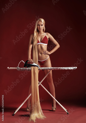 Conceptual picture of a woman ironing her hair