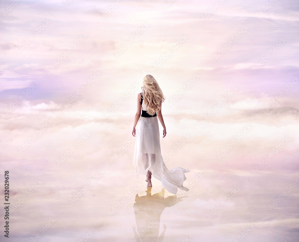 Conceptual picture of a blond lady walking on the delicate, fluffy clouds