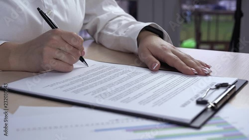 close up details unrecognizable businesswoman holding contract and sign a signature - fake signature