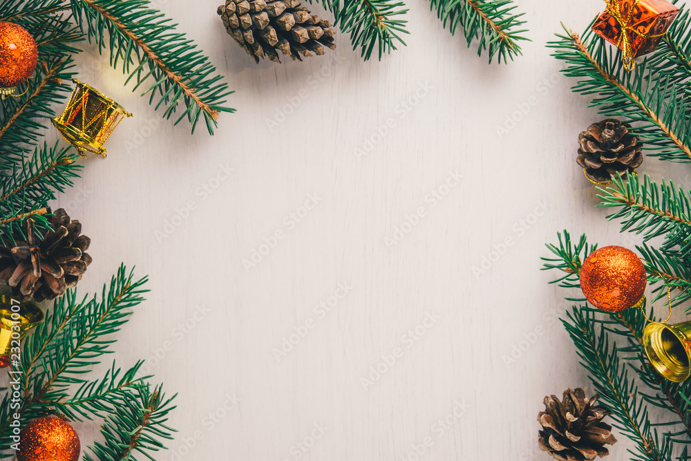Green spruce twigs, pine cones and red and golden Christmas decorations on white background with copy space Green spruce twigs, pine cones and red and golden Christmas decorations on white background with copy space