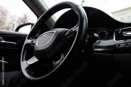 Steering wheel on the car dashboard and the driver's seat © Mashevur
