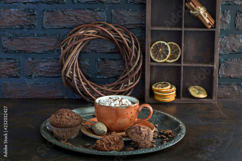 Hot chocolate with marshmallows and muffins on the table - background about dessert