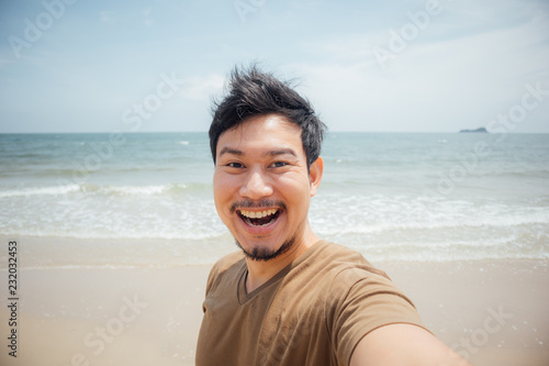 Cheerful and happy face of man selfie himself on the beach.