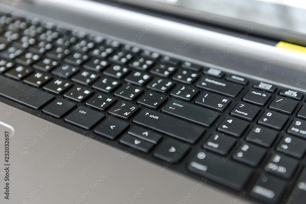 Close-up of notebook computer keyboard. selected focus on enter button. Close-up of notebook computer keyboard. selected focus on enter button.