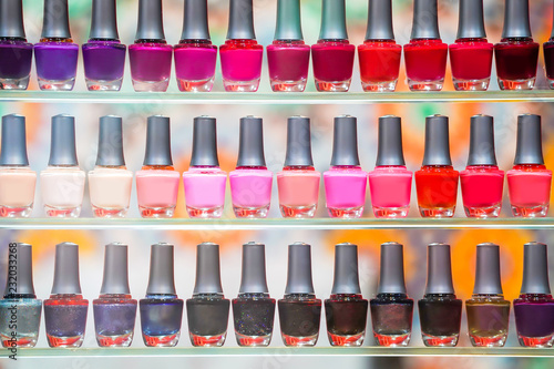 Beautiful display colorful nail polishs on shelf.