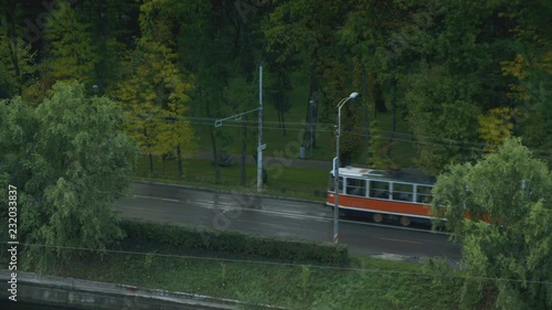 A tram trundles through the frame in Cluj Napoca, Romania photo