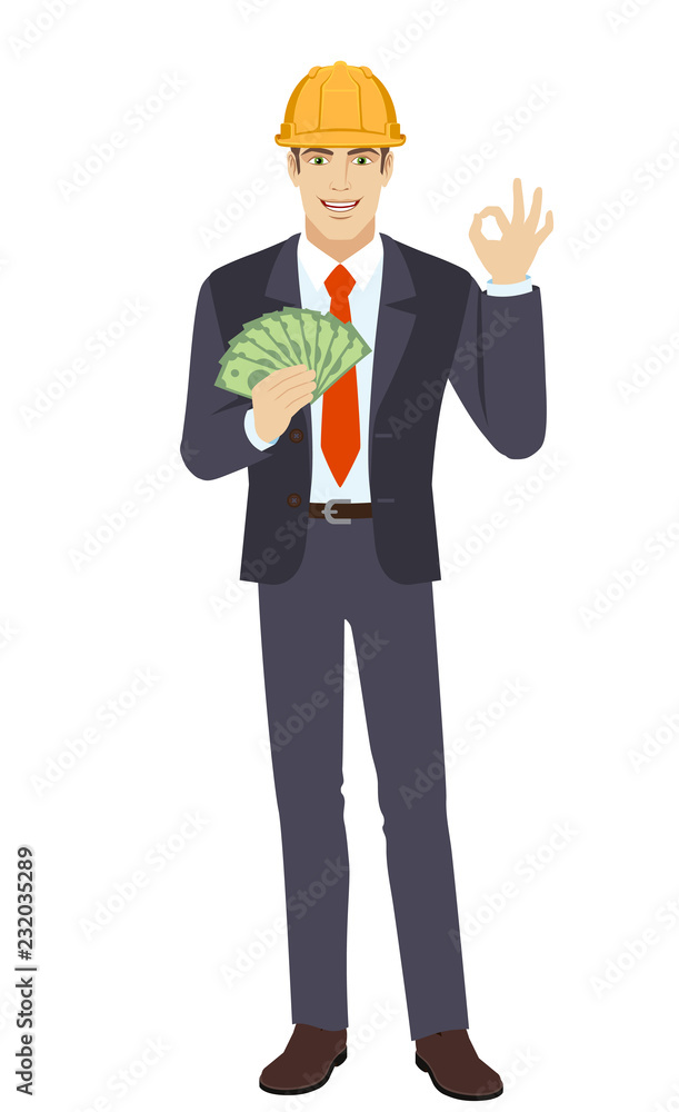 Businessman in construction helmet with money showing a okay hand sign Businessman in construction helmet with money showing a okay hand sign