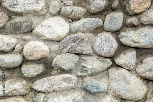 Old stone wall texture background close up