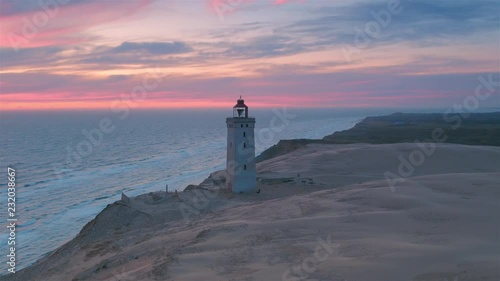 Stunning aerial wide shot of Rubjerg Knude lighthouse at sunset photo